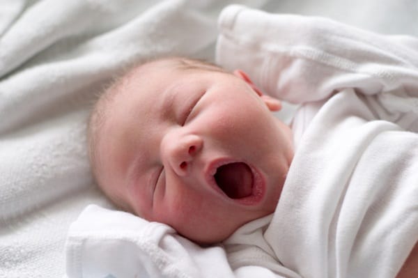 Yawning baby taking a nap